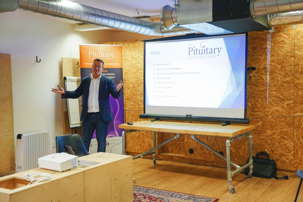 Man standing in front of a powerpoint presentation