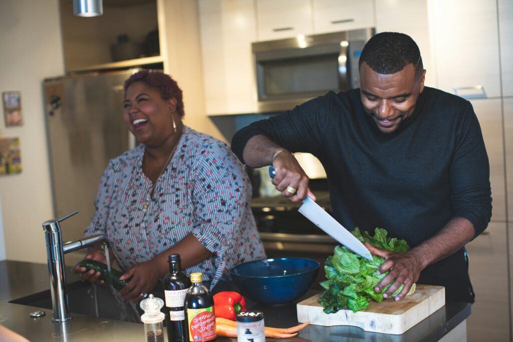 A young couple preparing food in the kitchen
