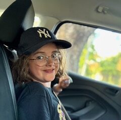 A young girl sat in a car
