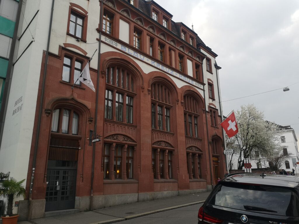 Hotel exterior with Swiss flag hanging by the window 