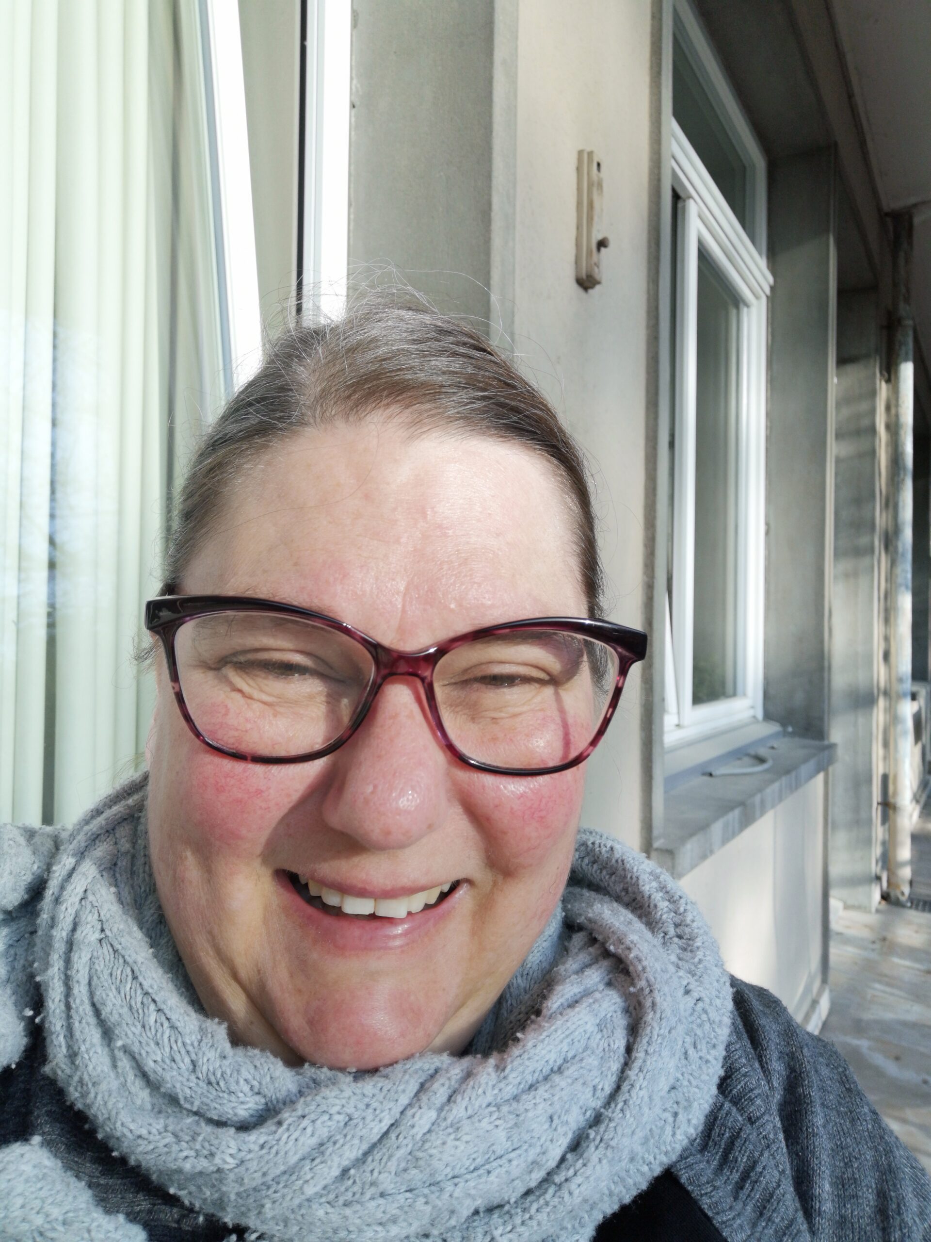 Shelley smiling on a balcony