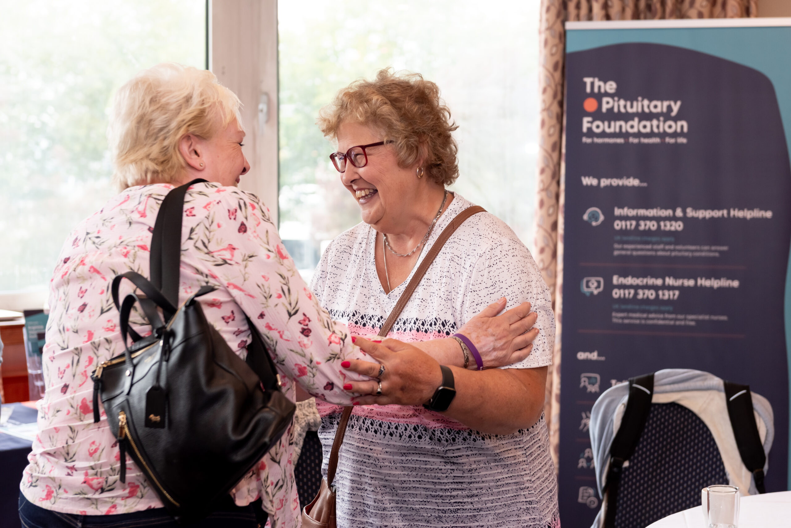 The Pituitary Foundation two women embracing and smiling